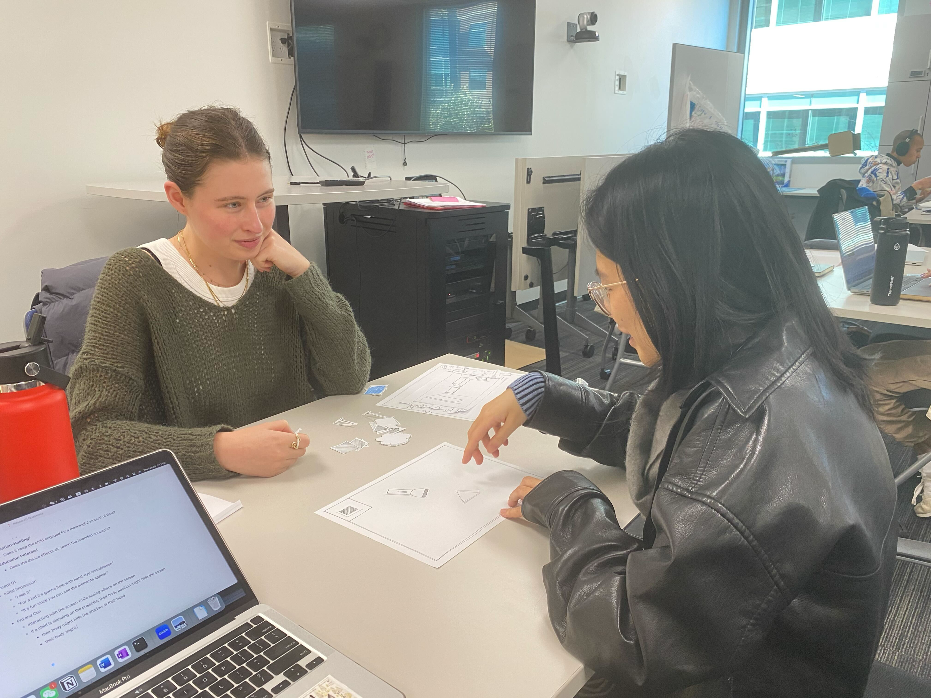 User feedback session discussing concept sketches